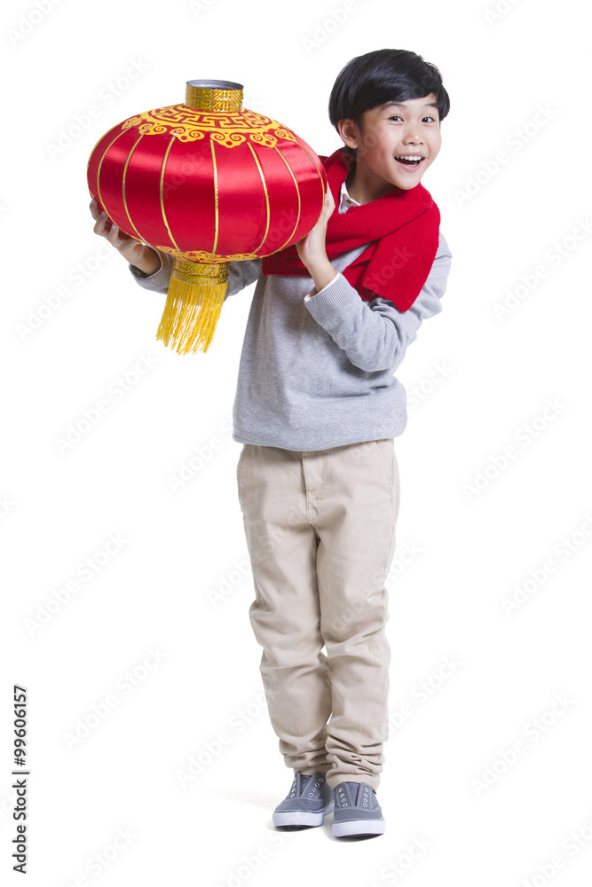 Cheerful boy with red lantern celebrating Chinese New Year