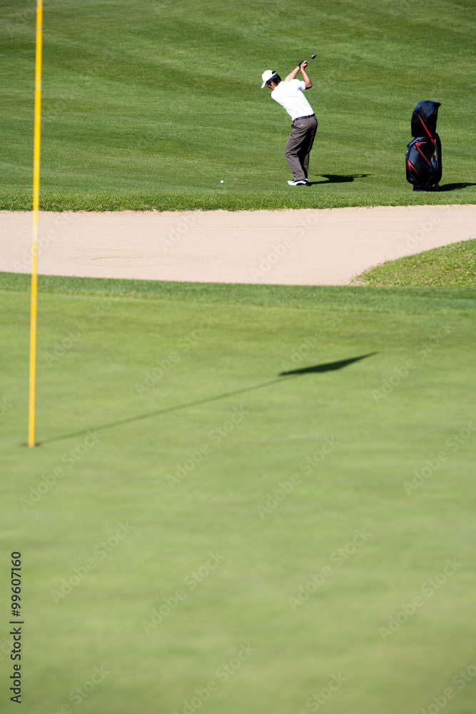 Young Man Taking a Golf Swing