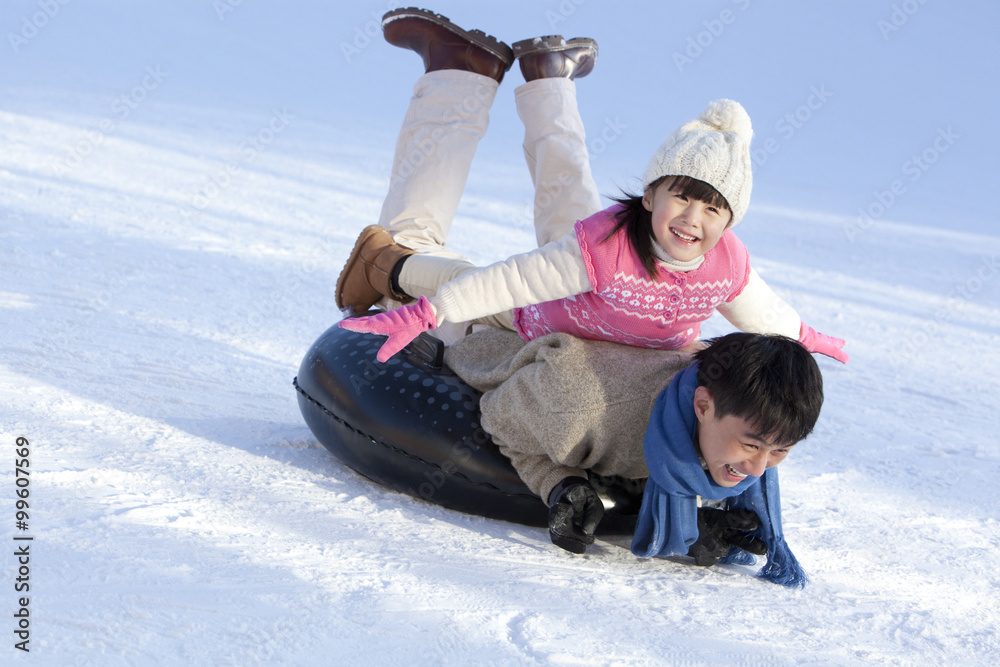 Father and daughter having fun in snow