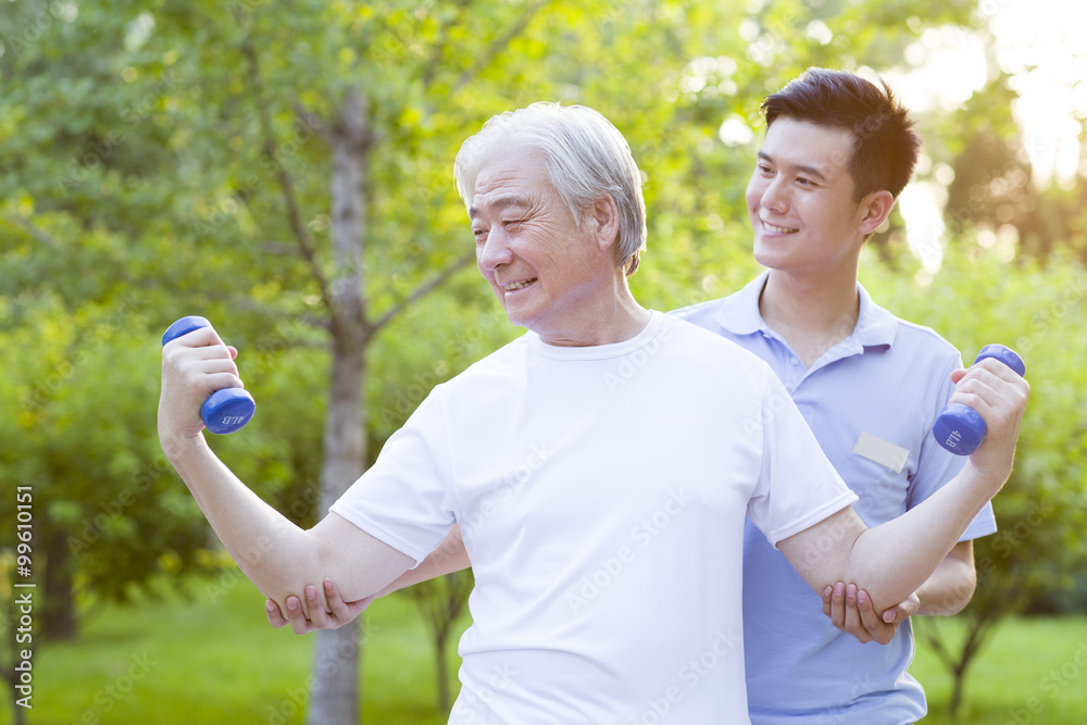 Senior man exercising with dumbbell in nursing home