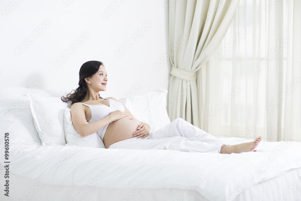 Pregnant woman resting in bed