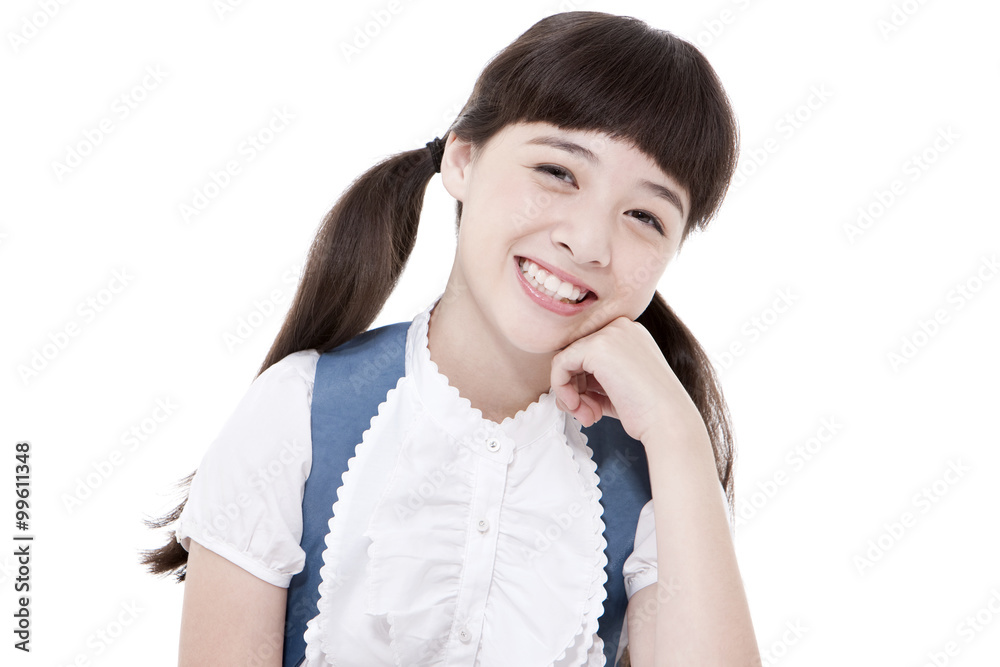 Cute schoolgirl smiling happily with hand on chin