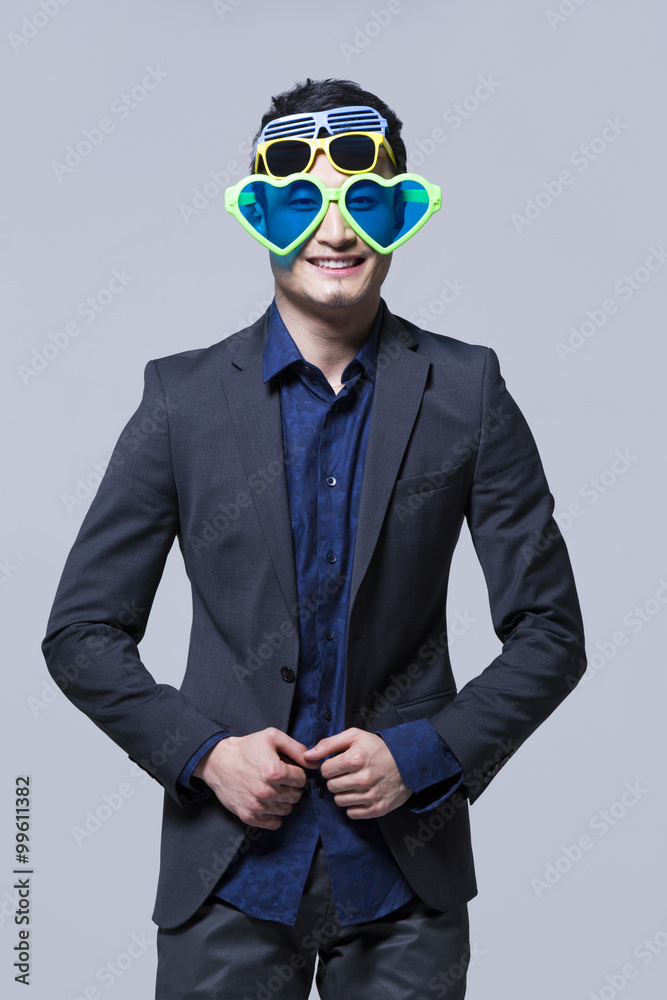 Hip young man wearing multiple pairs of sunglasses