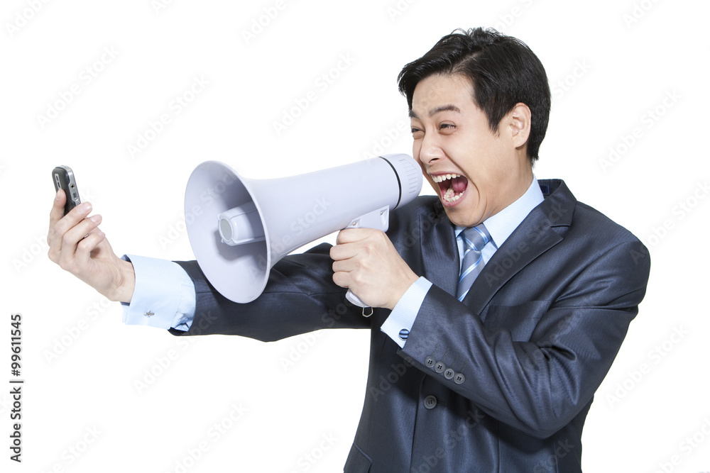 Portrait of a businessman shouting into a megaphone