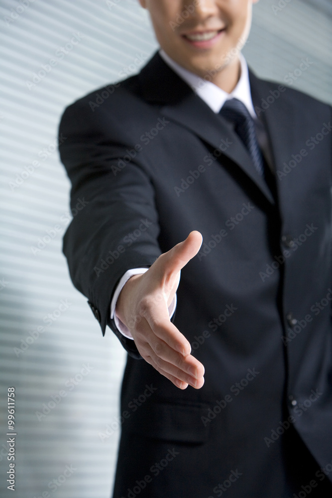 Businessman holding hand out