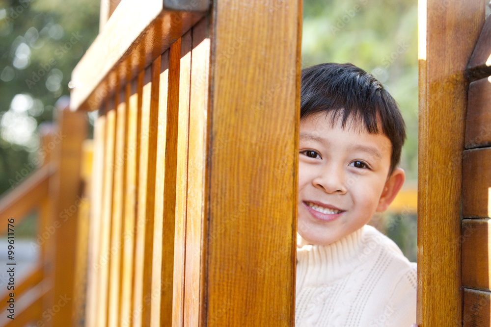 Boy hiding in playground toys