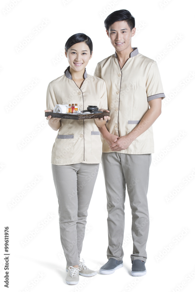 Massage therapists holding massage supplies