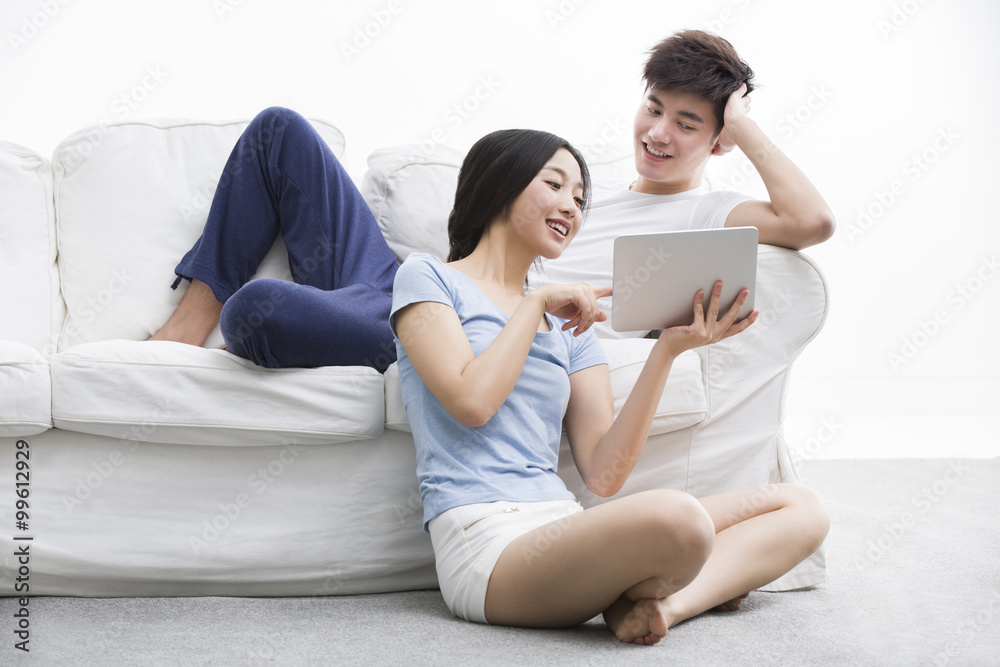 Young couple using digital tablet