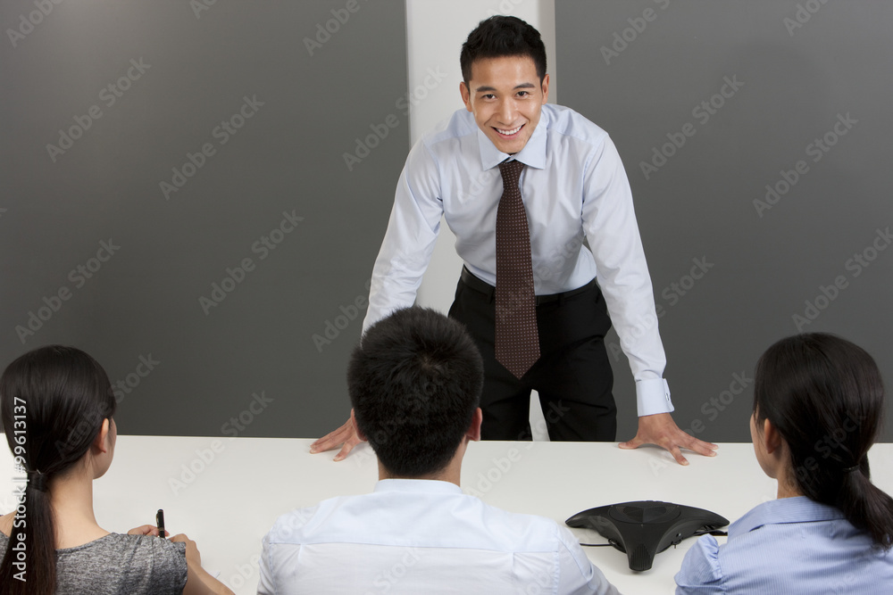 Confident Businessman In Front of Colleagues