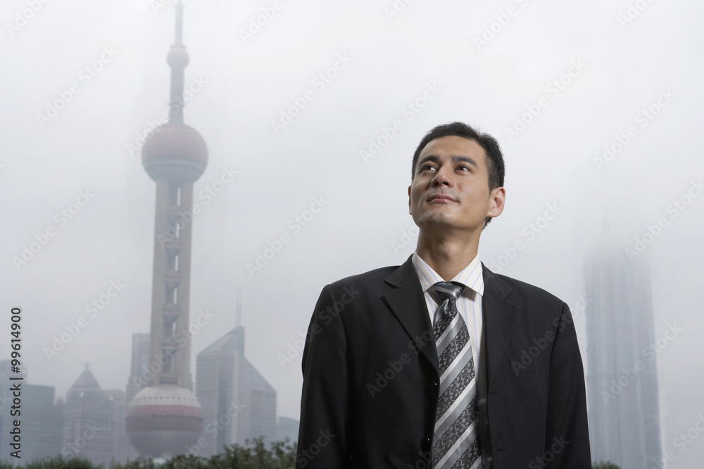 Businessman Standing In City Fog