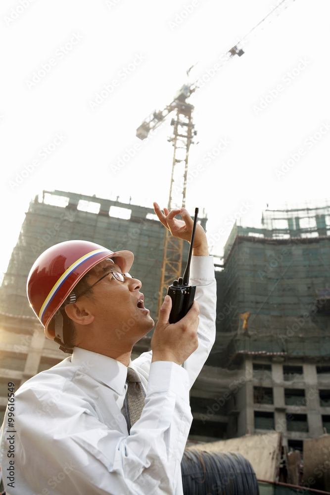 Construction Contractor Talking Into Walkie Talkie