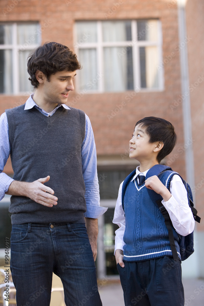 Teacher talking with a student on campus