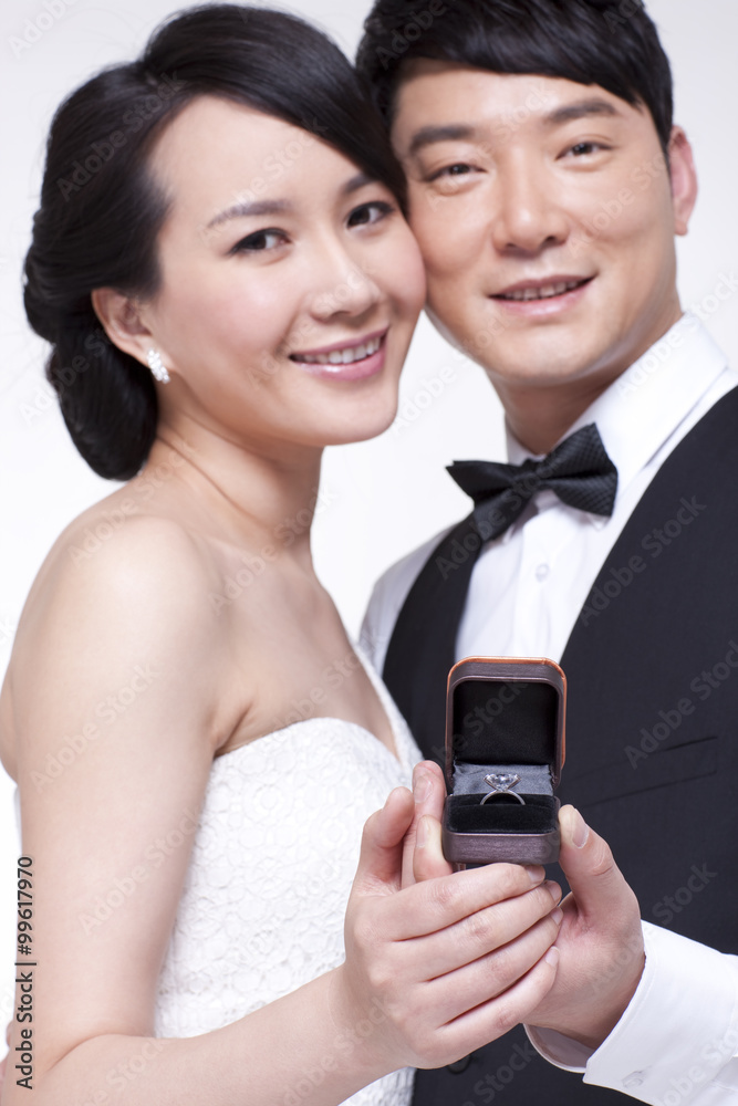 Happy young couple with diamond ring