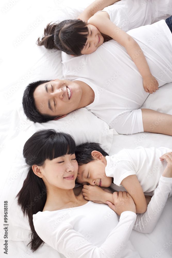 Happy family lying in bed