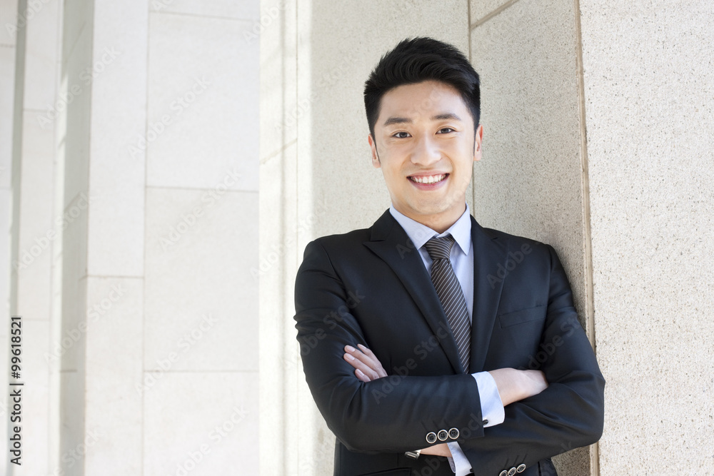 Professional businessman arms crossed in CBD