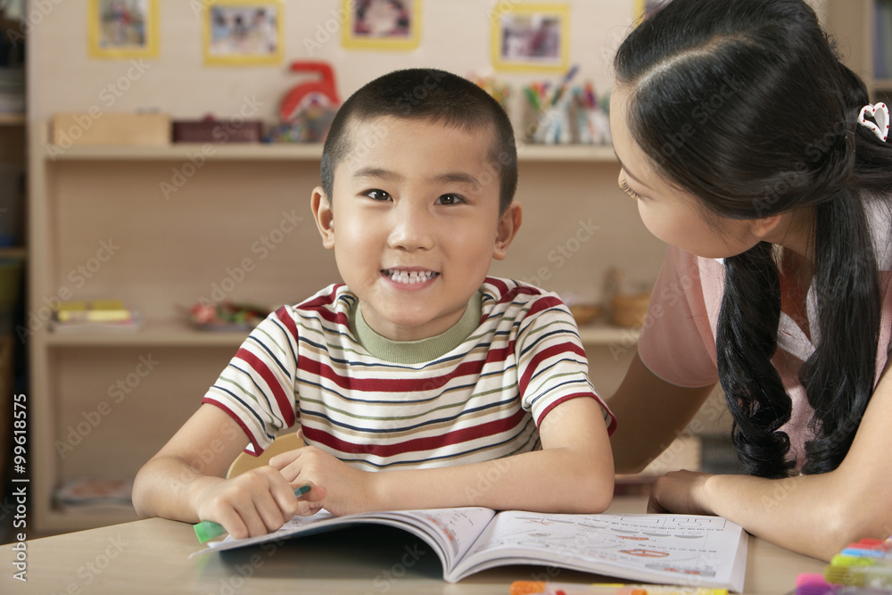 Teacher And Young Child Reading A Book