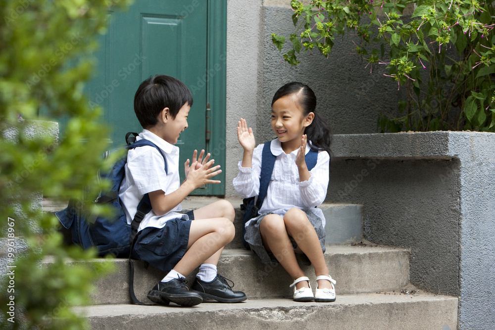 Two school children playing outside