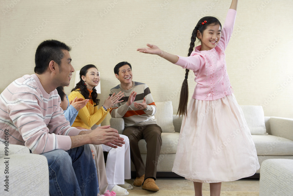 Adults Watching Girl Performing In Living Room