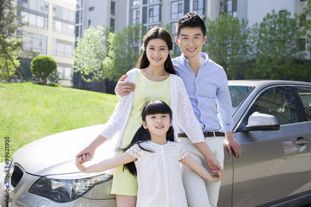 Happy young family and car