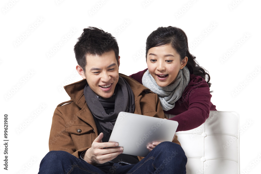 Young couple using digital tablet