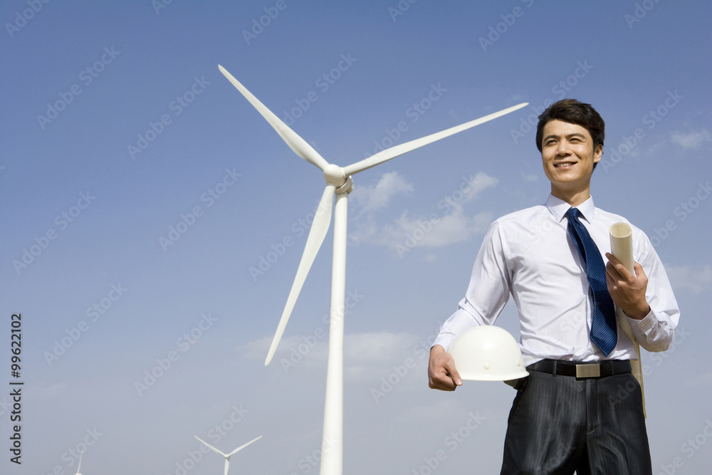 Engineer in front of wind turbines