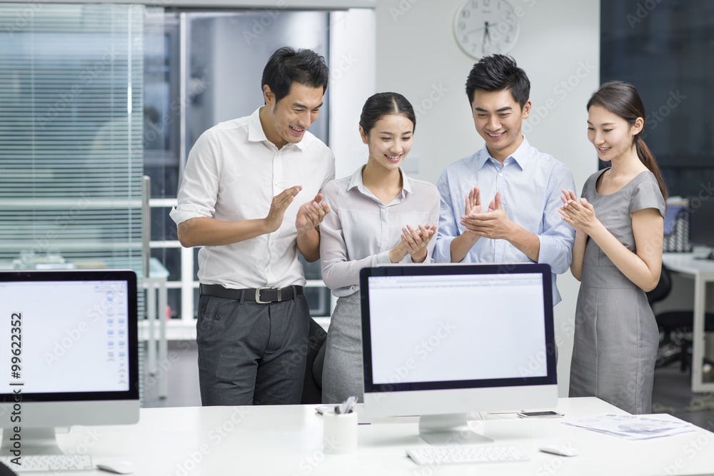 Young business people using computer in office