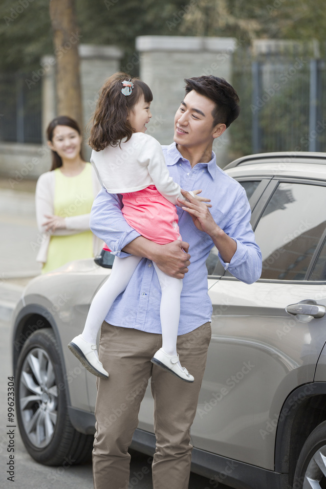 Happy father holding daughter in his arms