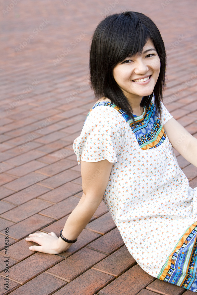 Young woman sitting on ground