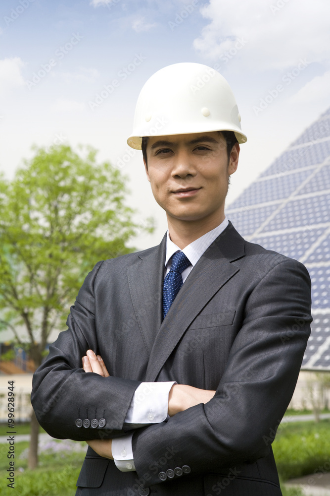 Portrait of an engineer in front of solar panels