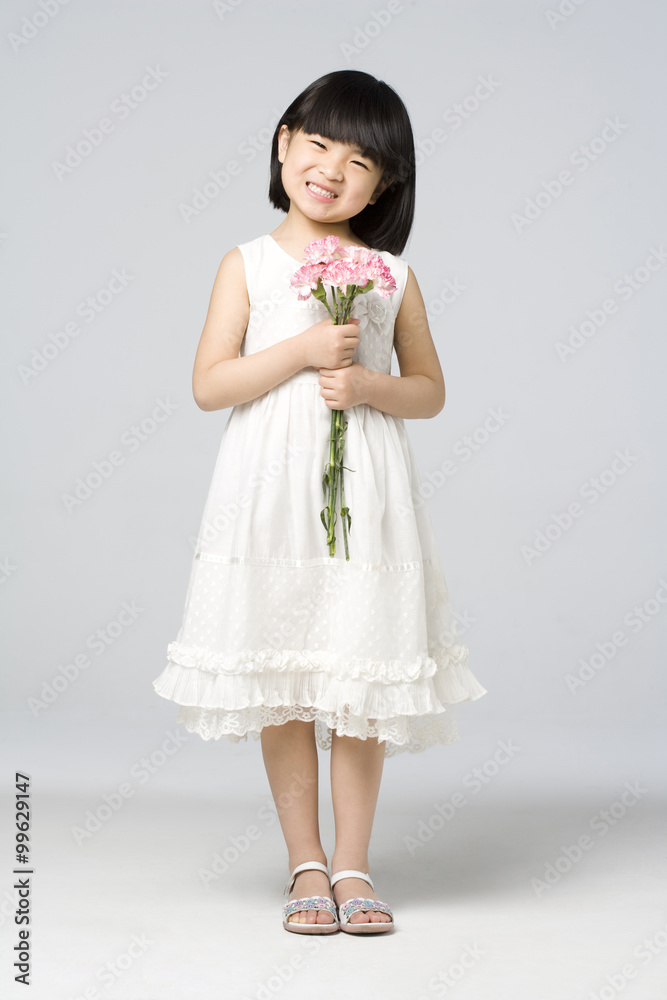 Little girl holding a bunch of flowers