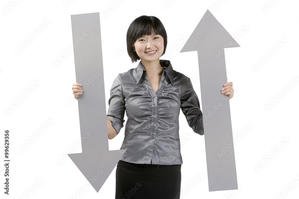 Young businesswoman holding arrow