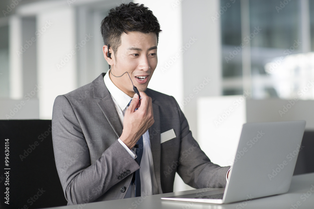 Young businessman using laptop