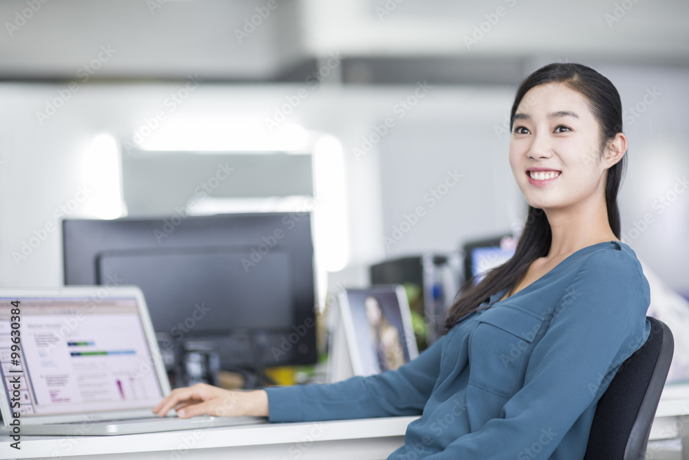 Young businesswoman thinking in office