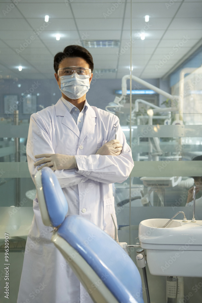 Dentist Standing In Dental Surgery