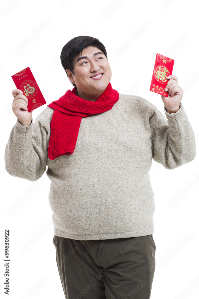 Chubby young man with red packets celebrating Chinese New Year