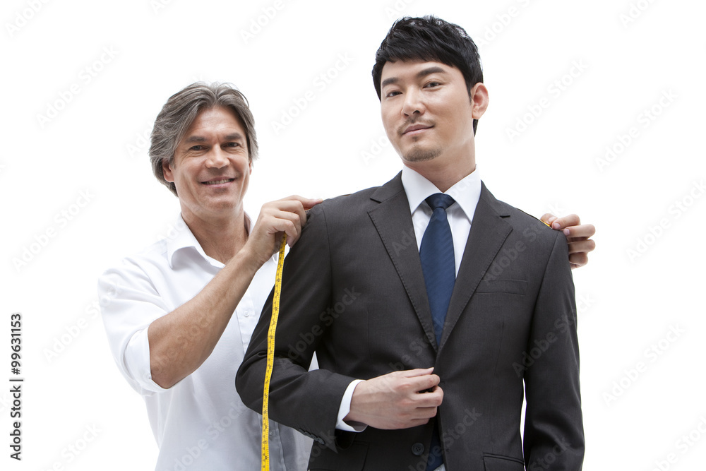 Fashion designer taking a measurement of  businessman