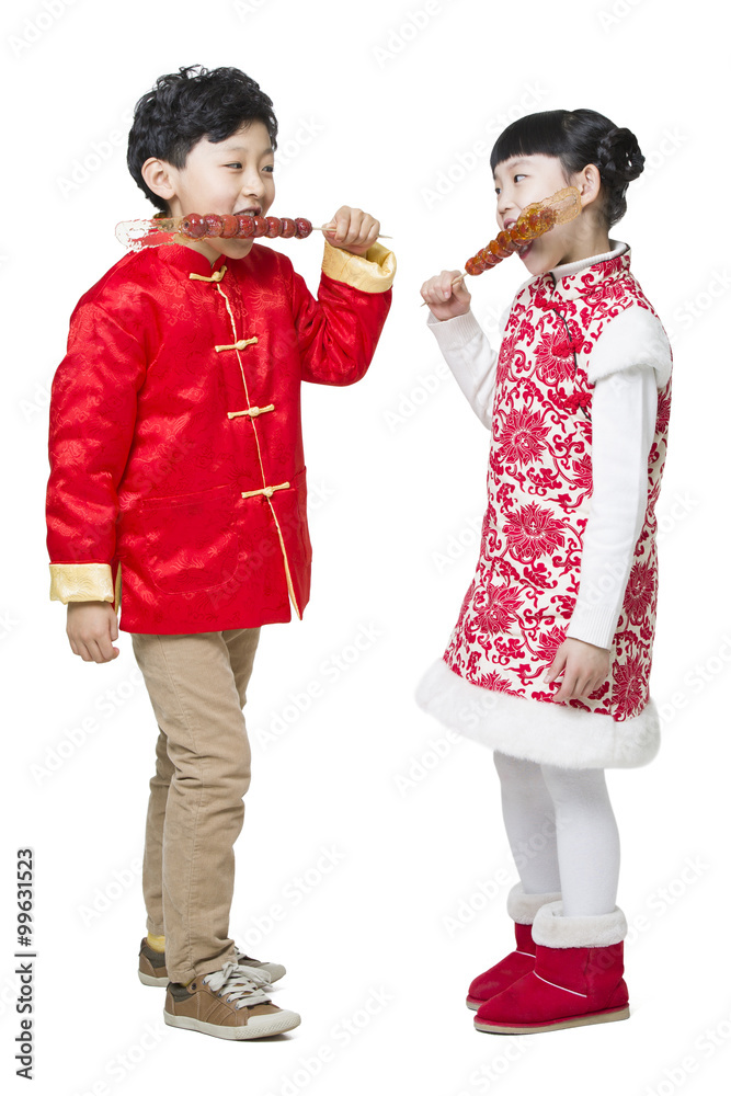 Cute children eating candied haws