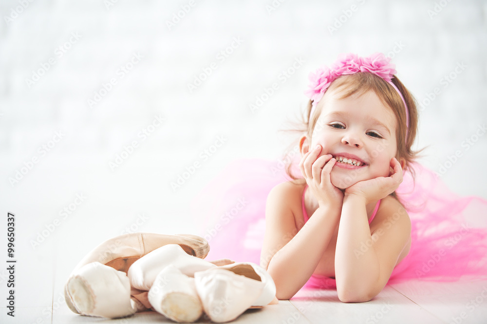 little child girl dreams of becoming  ballerina with ballet shoe