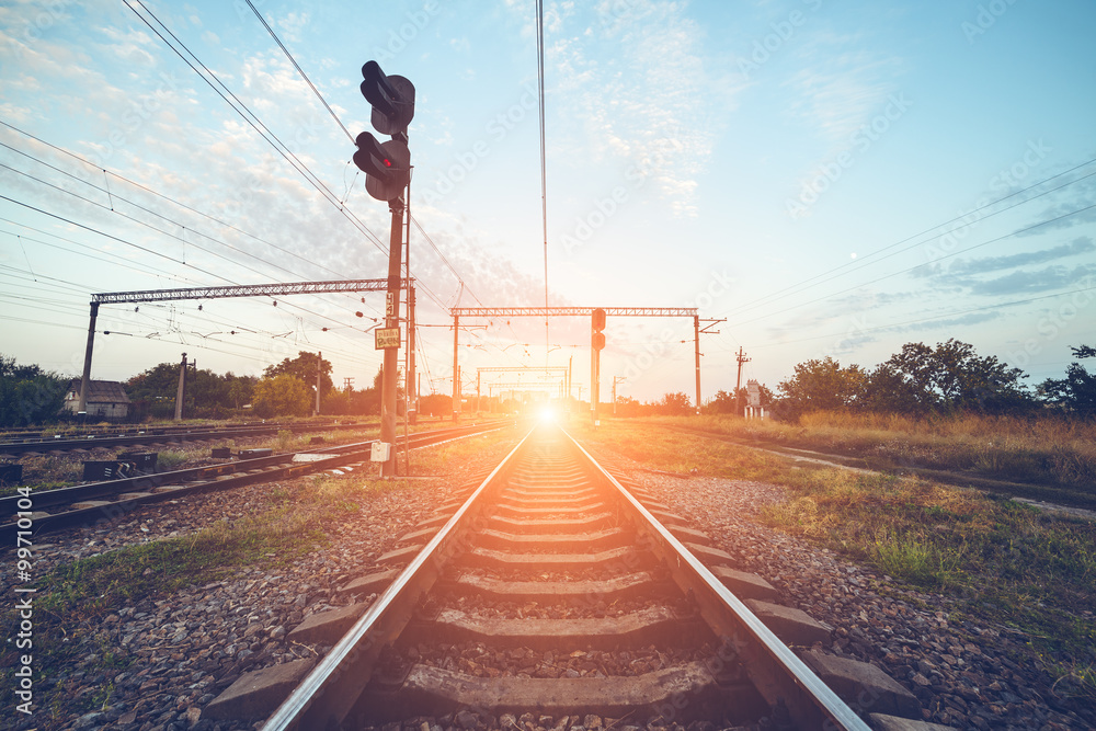 Train platform and traffic light at sunset. Railroad. Railway st