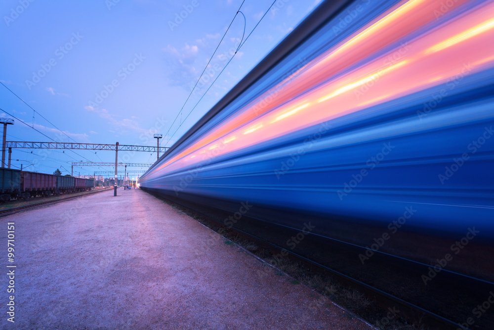 High speed passenger train on tracks with motion blur effect