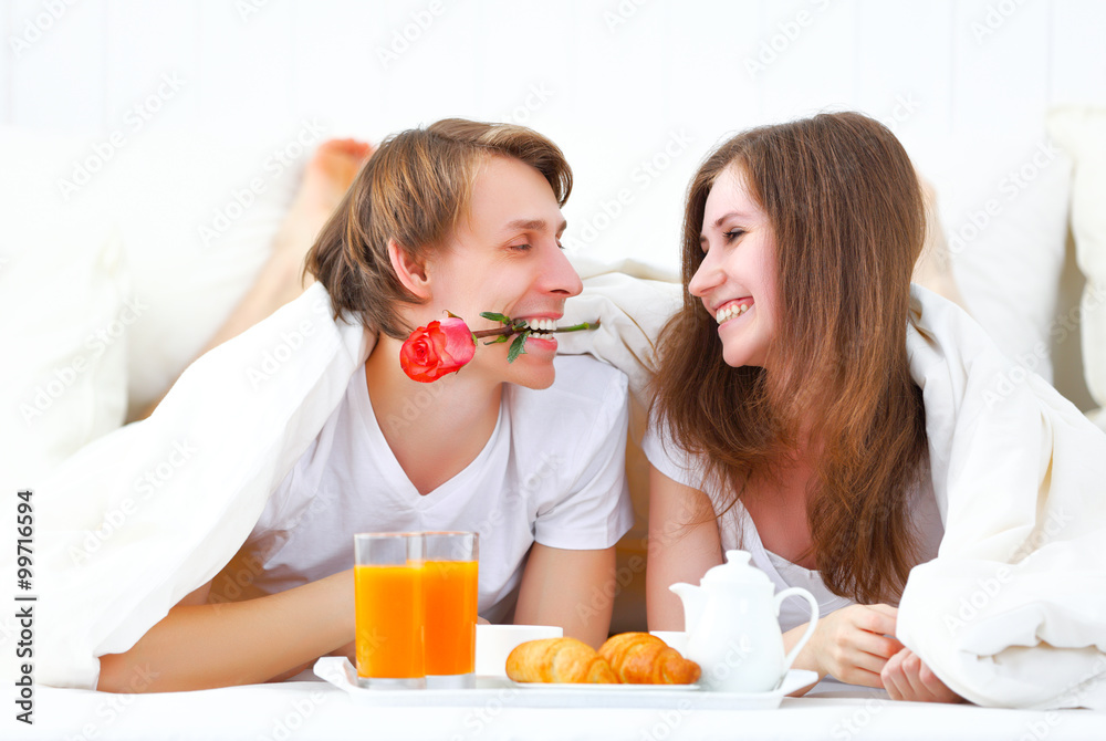 loving couple having breakfast in bed