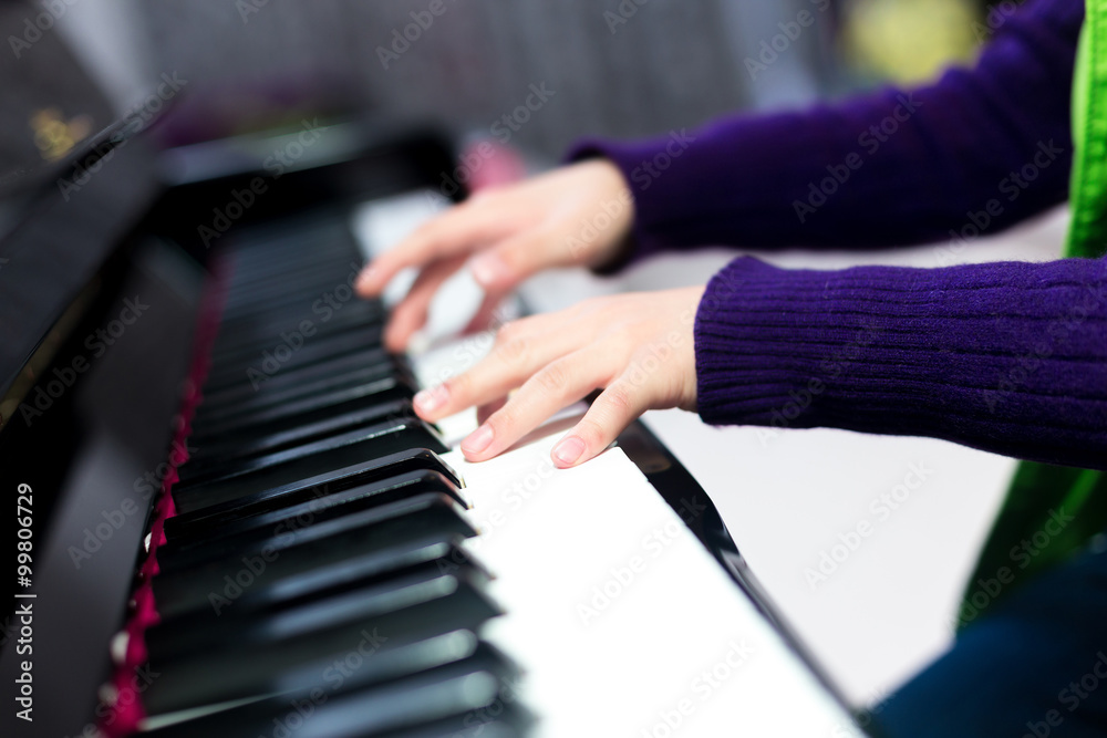 Asian cute boy playing piano at home