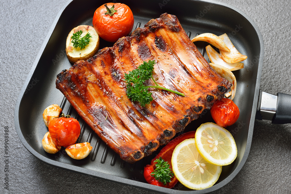 Grilled pork ribs and vegetables on the grill pan