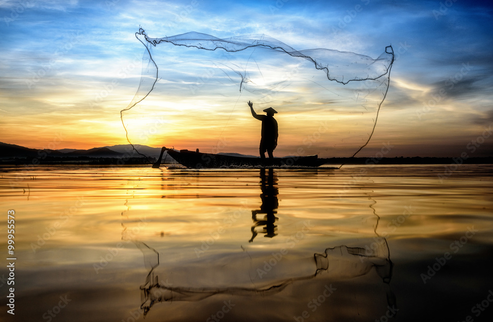 Fisherman in action when fishing in the lake , Thailand