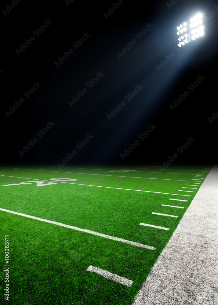 Football field illuminated by stadium lights