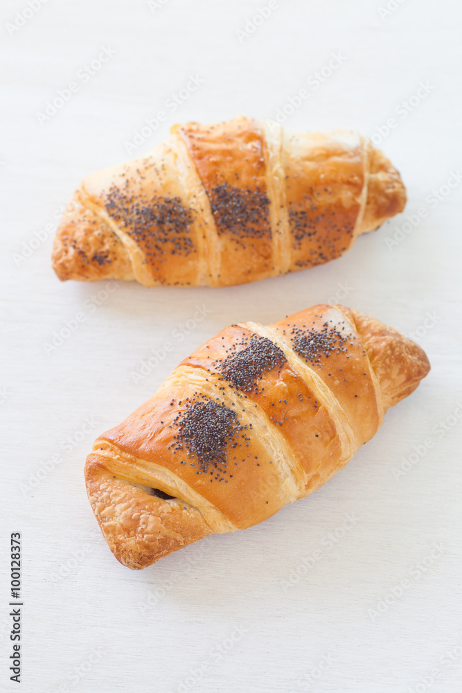 Fresh and tasty croissant over white background