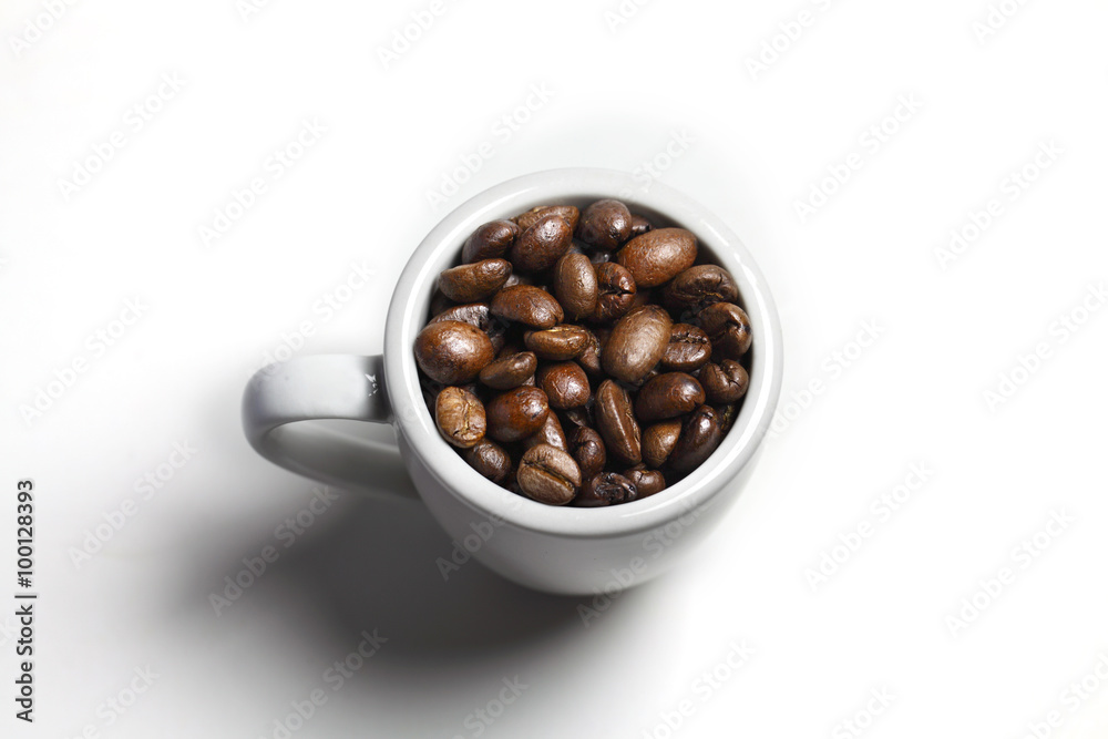 Coffee beans in cup on white background