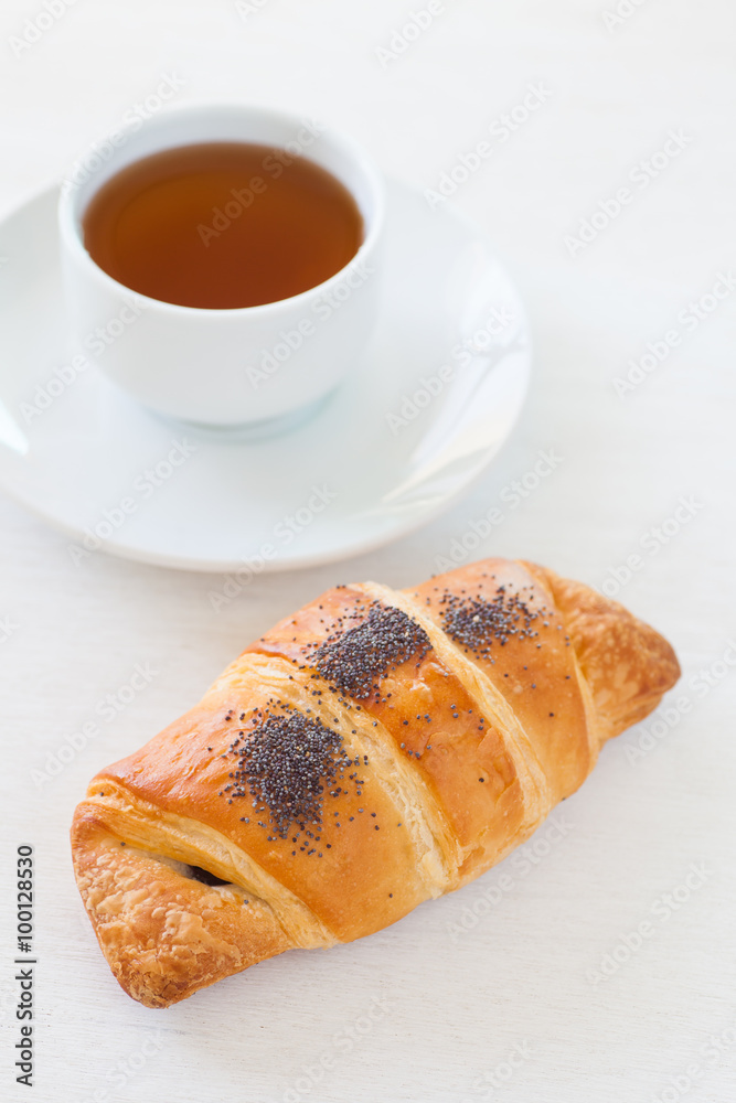 Fresh and tasty croissant and hot tea