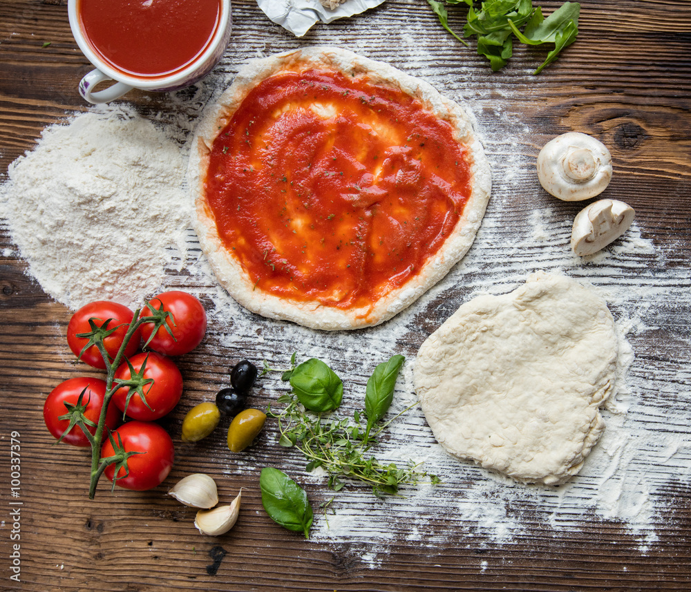 Pizza dough on rustic wooden table