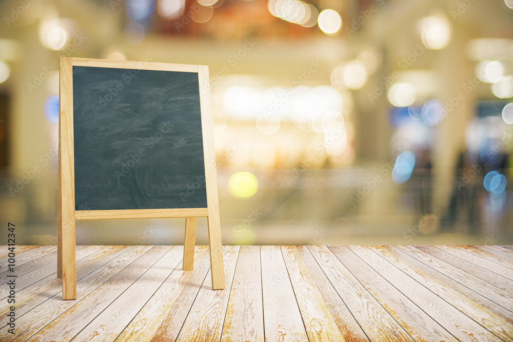 Blank restaurant blackboard on wooden floor, mock up